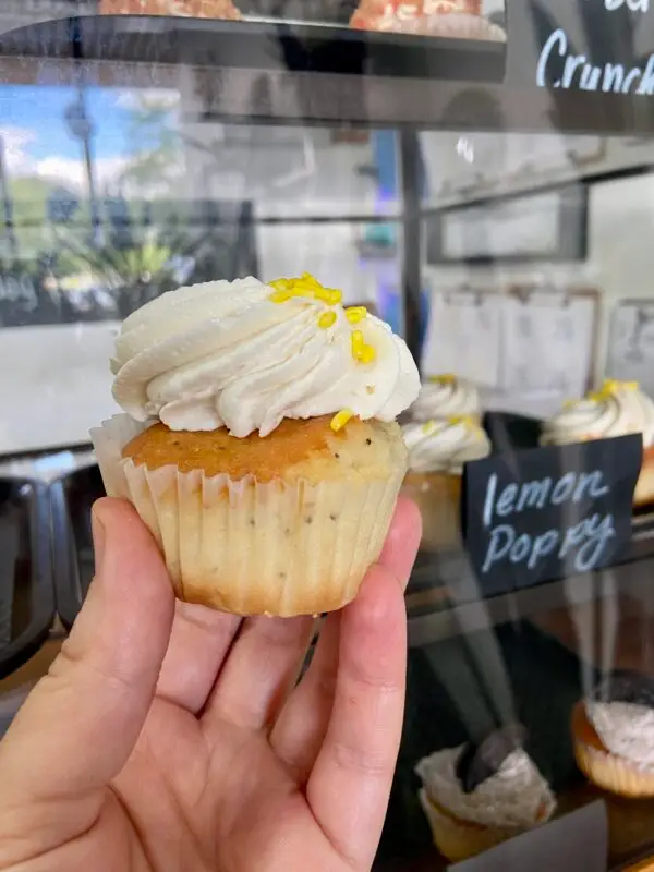 Lemon poppy flavored cupcake with vanilla icing and sprinkle garnish