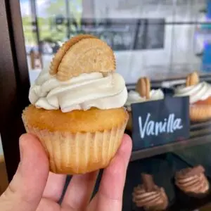 Vanilla cupcake with vanilla icing and slice of vanilla sandwich cookie to garnish