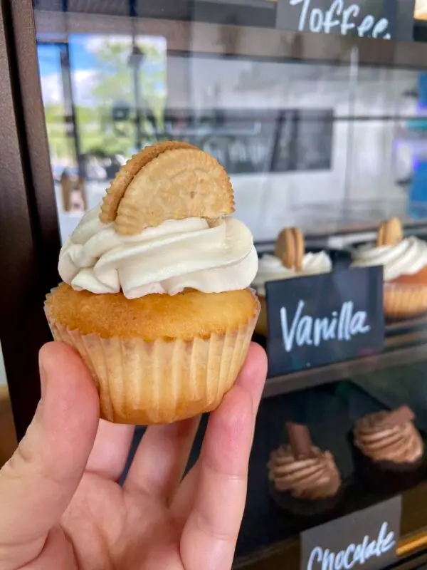 Vanilla cupcake with vanilla icing and slice of vanilla sandwich cookie to garnish