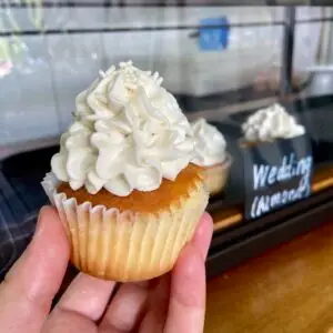 Almond cake with vanilla icing and sprinkle garnish