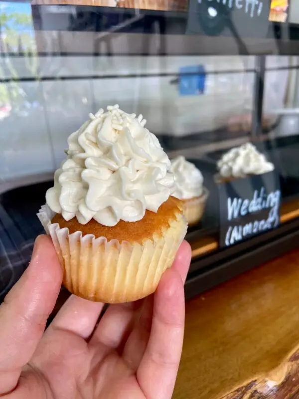 Almond cake with vanilla icing and sprinkle garnish